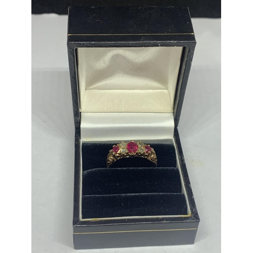 674 - A 9 CARAT GOLD RING WITH THREE IN LINE RUBYS AND FOUR DIAMONDS SIZE P WITH A PRESENTATION BOX