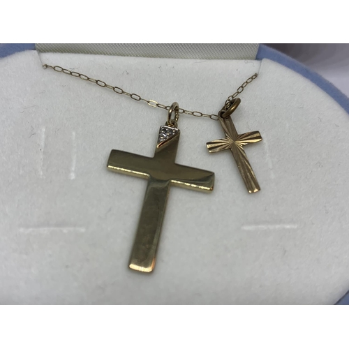 563 - A 9 CARAT GOLD CHAIN WITH TWO 9 CARAT GOLD CROSS PENDANTS ONE WITH CLEAR STONE CHIP DESIGN IN A PRES... 