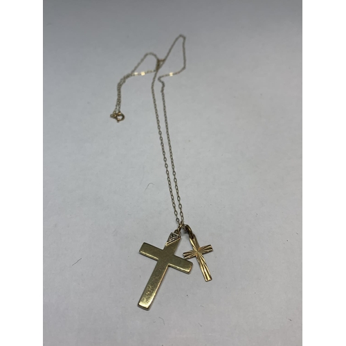 563 - A 9 CARAT GOLD CHAIN WITH TWO 9 CARAT GOLD CROSS PENDANTS ONE WITH CLEAR STONE CHIP DESIGN IN A PRES... 