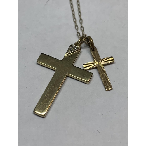 563 - A 9 CARAT GOLD CHAIN WITH TWO 9 CARAT GOLD CROSS PENDANTS ONE WITH CLEAR STONE CHIP DESIGN IN A PRES... 