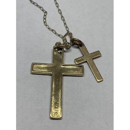 563 - A 9 CARAT GOLD CHAIN WITH TWO 9 CARAT GOLD CROSS PENDANTS ONE WITH CLEAR STONE CHIP DESIGN IN A PRES... 