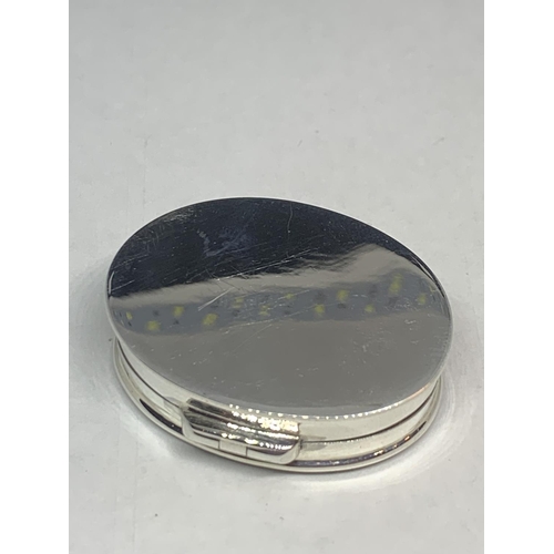 599 - A MARKED SILVER PILL BOX WITH AN ENAMEL EROTIC DESIGN TOP