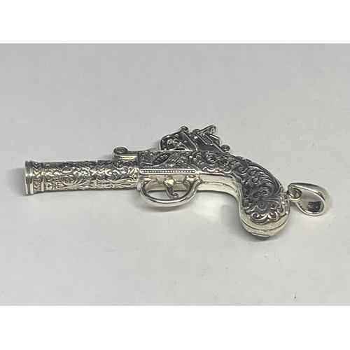 606 - A MARKED SILVER PENDANT IN THE GUISE OF A PISTOL