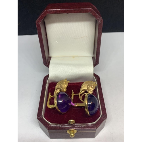 531 - A PAIR OF 12 CARAT YELLOW GOLD HORSES HEAD  DESIGN EARRINGS WITH CABOUCHON AMETHYST  DECORATION BY L... 