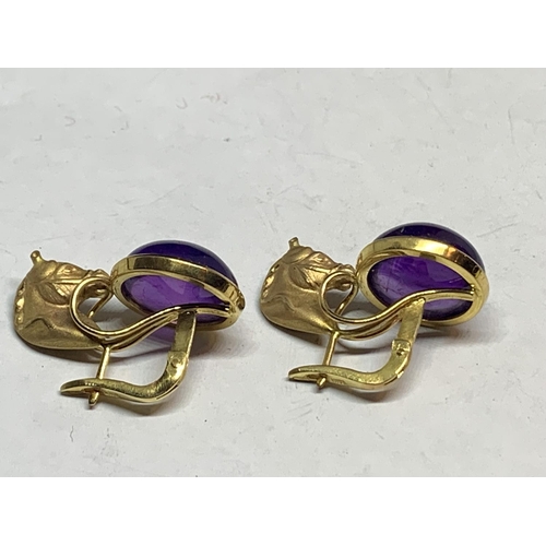 531 - A PAIR OF 12 CARAT YELLOW GOLD HORSES HEAD  DESIGN EARRINGS WITH CABOUCHON AMETHYST  DECORATION BY L... 