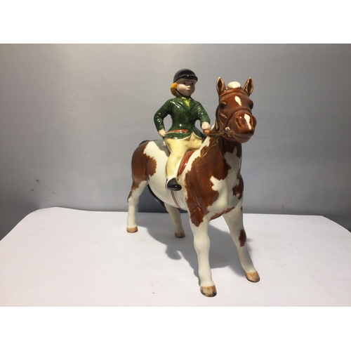 759 - A BESWICK SKEWBALD PONY WITH GIRL RIDER