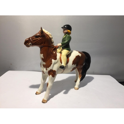 759 - A BESWICK SKEWBALD PONY WITH GIRL RIDER