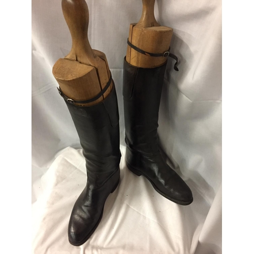 141 - A PAIR OF LEATHER RIDING BOOTS WITH VINTAGE WOODEN BOOT SUPPORTS