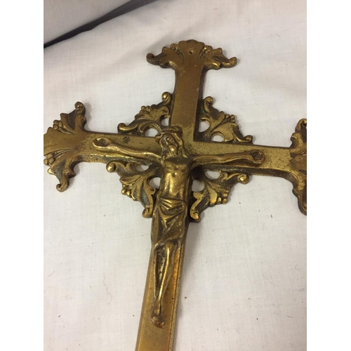 200 - A BRASS CRUCIFIX AND A BRASS CALENDER