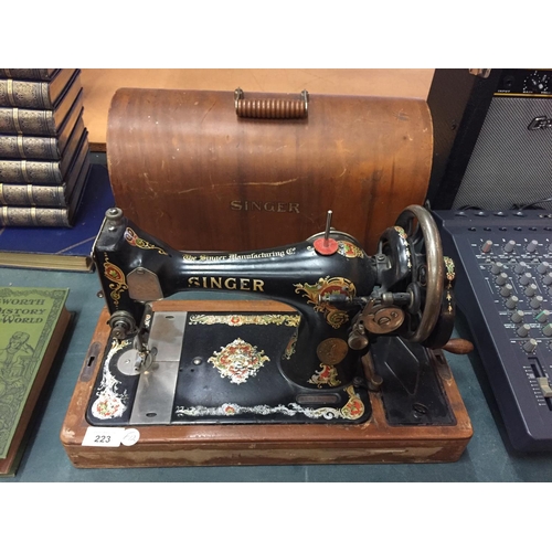 223 - A VINTAGE SINGER SEWING MACHINE IN A CASE