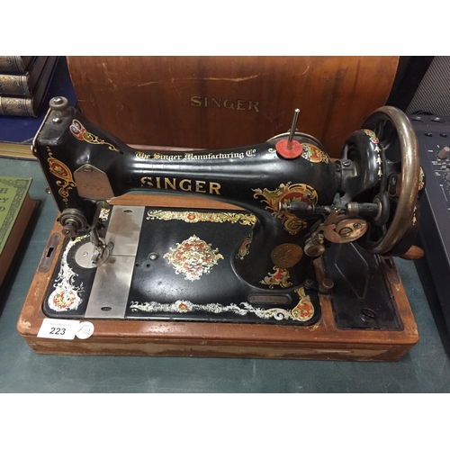 223 - A VINTAGE SINGER SEWING MACHINE IN A CASE