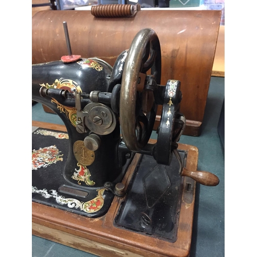 223 - A VINTAGE SINGER SEWING MACHINE IN A CASE