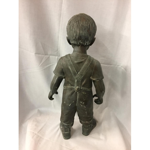 261 - A RESIN MODEL OF A YUNG BOY IN DUNGAREES (HAND A/F)