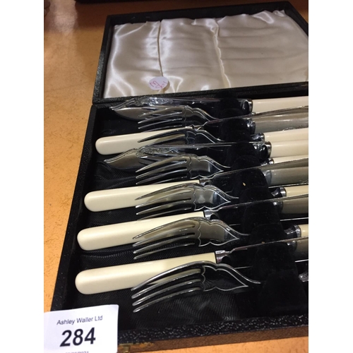 284 - SIX FISH KNIVES AND FORKS IN A PRESENTATION BOX