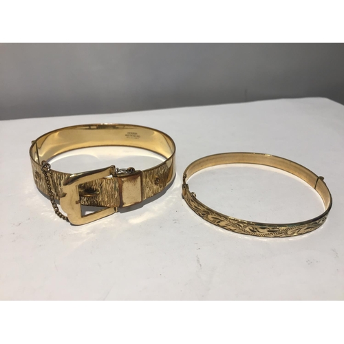 620 - TWO ROLLED GOLD BANGLES