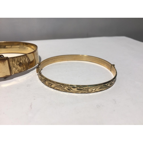 620 - TWO ROLLED GOLD BANGLES