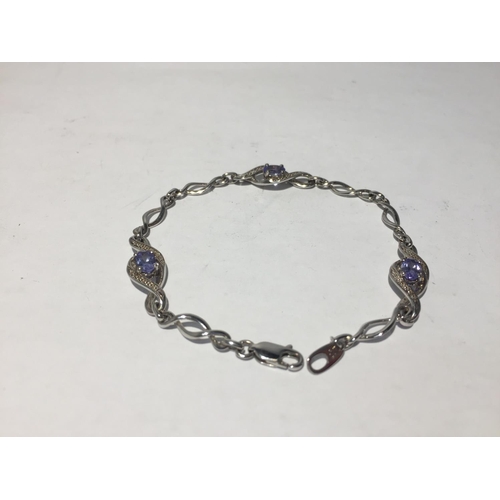 621 - A SILVER BRACELET WITH POSSIBLY AQUAMARINES AND DIAMOND CHIPS