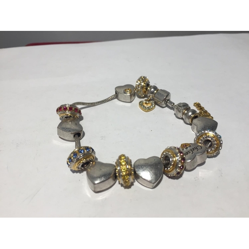 633 - A BRADFORD EXCHANGE SILVER CHARM BRACELET WITH CHARMS TO INCLUDE HEARTS AND COLOURED STONES