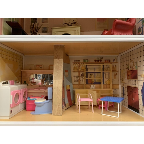 315A - A VERY LARGE THREE STOREY SINDY DOLLS HOUSE WITH ROOF TOP TERRACE TO INCLUDE SINDY FURNITURE