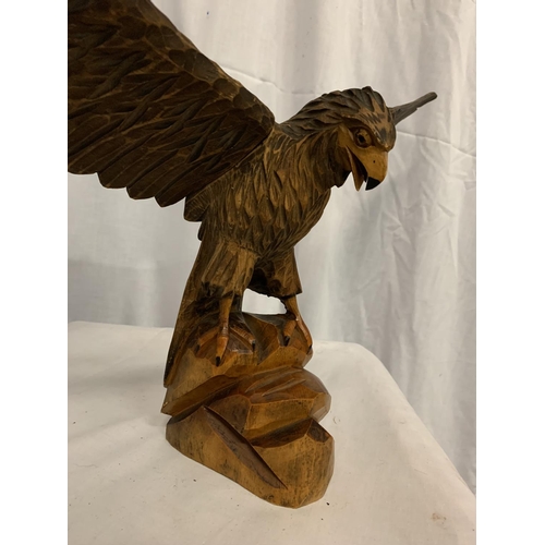 101 - A WOODEN CARVED FIGURE OF AN EAGLE WITH ADJUSTABLE WINGS