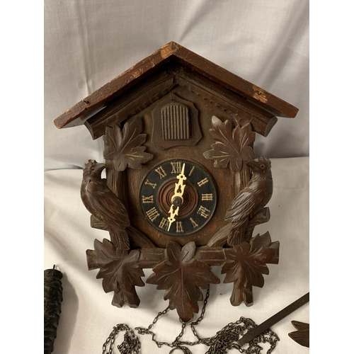 26 - A CARVED WOODEN CUCKOO CLOCK WITH ONE WEIGHT