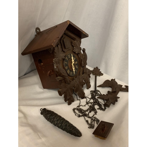 26 - A CARVED WOODEN CUCKOO CLOCK WITH ONE WEIGHT