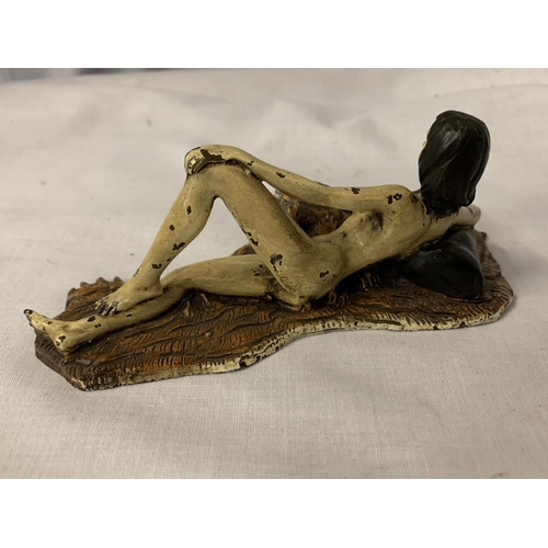 28 - A COLD PAINTED BRONZE FIGURINE OF A NUDE LADY LYING ON A TIGER RUG