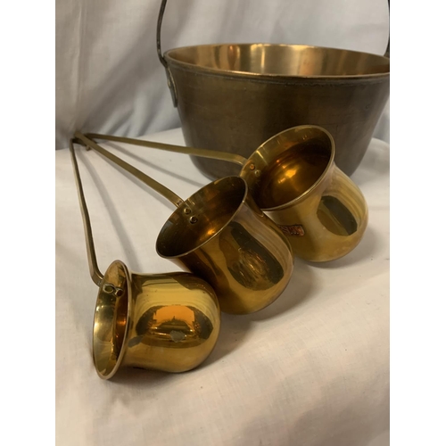 29 - A BRASS JAM PAN AND THREE BRASS LADLES