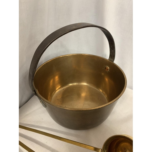 29 - A BRASS JAM PAN AND THREE BRASS LADLES