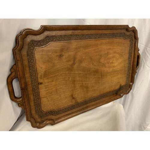 30 - A VINTAGE DECORATIVE CARVED WOODEN TRAY L:64CM