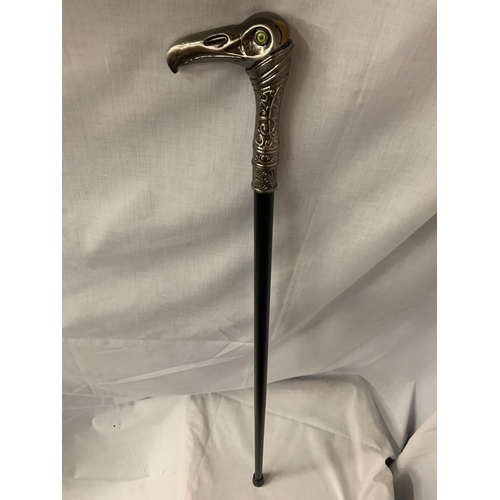 35 - A WALKING STICK WITH A METAL EAGLES HEAD HANDLE