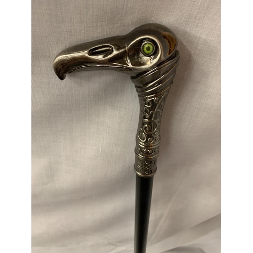 35 - A WALKING STICK WITH A METAL EAGLES HEAD HANDLE