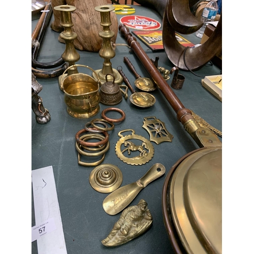 55 - A COLLECTION OF BRASS WARE TO INCLUDE WARMING PAN, CANDLESTICKS, HORSE BRASSES ETC