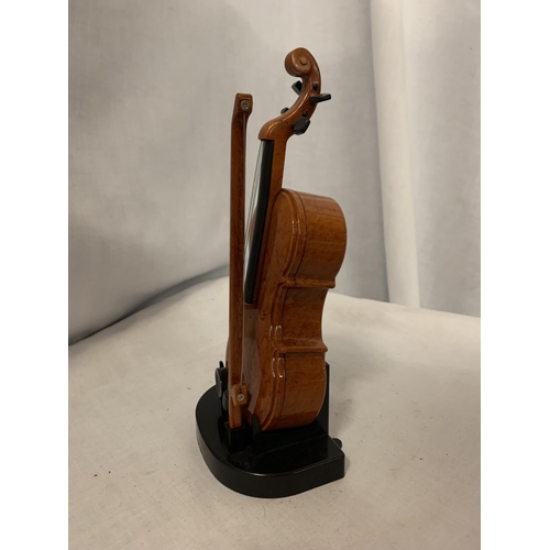 59 - AN ORNAMENTAL MUSICAL DOUBLE BASE WITH STAND AND BOW