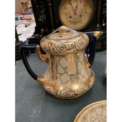 66 - AN EARLY CREAM AND GILT TEAPOT, HOT WATER JUG AND STAND