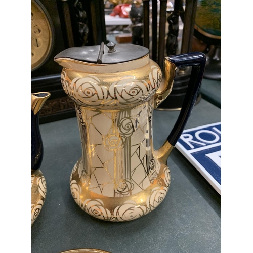 66 - AN EARLY CREAM AND GILT TEAPOT, HOT WATER JUG AND STAND