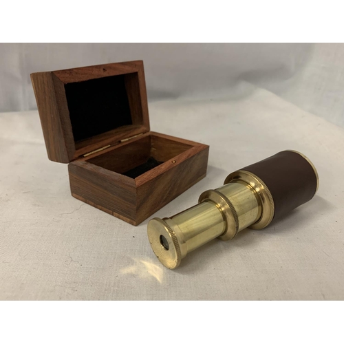 73 - A MINI BRASS AND LEATHER TELESCOPE IN WOODEN BOX