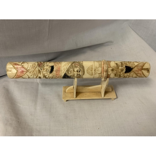 82 - A DECORATIVE BONE 'HEMPEL'S' LETTER OPENER ON STAND DEPICTING ORIENTAL STYLE SCENES