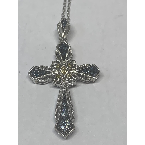 654 - TWO SILVER NECKLACES BOTH WITH ORNATE COLOURED STONE PENDANTS TO INCLUDE A CROSS