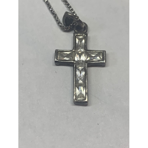 658 - TWO SILVER NECKLACES WITH CLEAR STONE PENDANTS N AND A CROSS