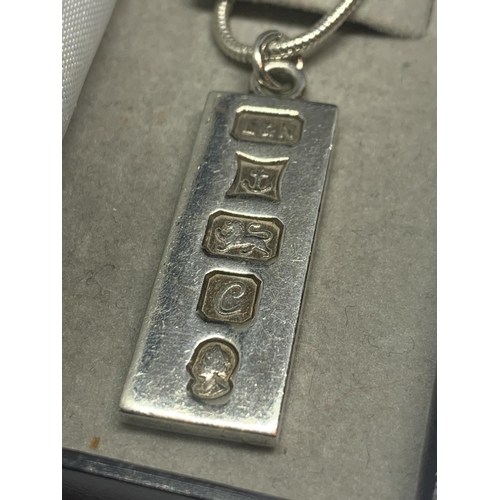 669 - A SILVER INGOT ON A CHAIN IN A PRESENTATION BOX