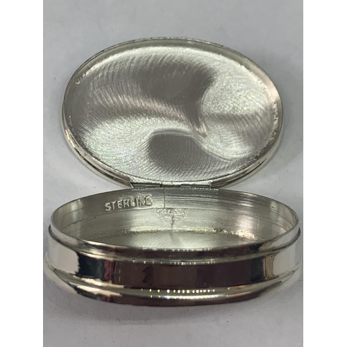 697 - A MARKED SILVER PILL BOX WITH AN EROTIC DESIGN LID