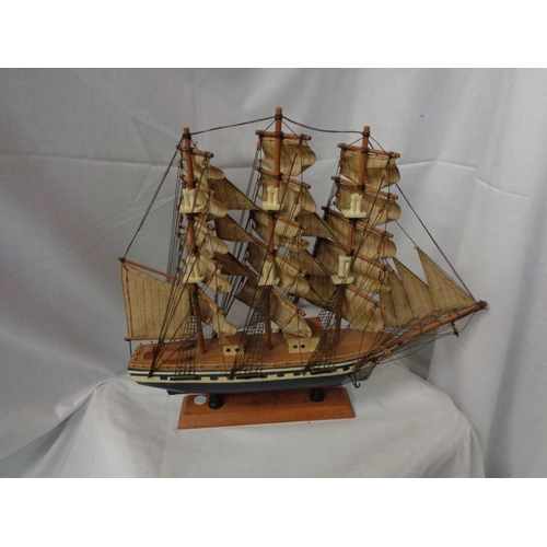 831 - A WOODEN MODEL OF THE SAILING SHIP FLYING CLOUD ON A PLINTH L:51CM