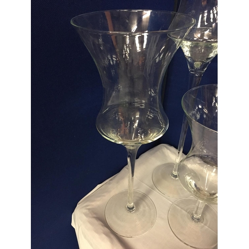 12 - THREE LARGE GLASS CANDLE HOLDERS
APPROXIMATE HEIGHTS 70CM 55CM 40CM