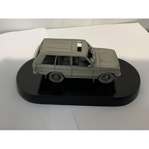 191 - A PEWTER RANGE ROVER ON A PLINTH WITH A BOX