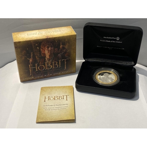 320 - A NEW ZEALAND “HOBBIT”, 1 OUNCE SILVER PROOF COIN WITH GOLD PLATING,  SUPERBLY BOXED WITH CCERTIFICA... 