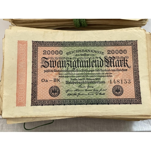 393 - A FOLDER CONTAINING A LARGE QUANTITY OF 1923 ZWANZIGTAUSEND MARK GERMAN BANK NOTES