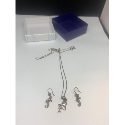 521 - A SILVER NECKLACE WITH A DOLPHIN PENDANT AND A PAIR OF SEAHORSE EARRINGS WITH A PRESENTATION BOX