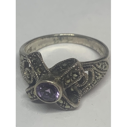 522 - A SILVER MARCASITE RING WITH PURPLE CENTRE STONE AND A PAIR OF MATCHING EARRINGS IN A PRESENTATION B... 