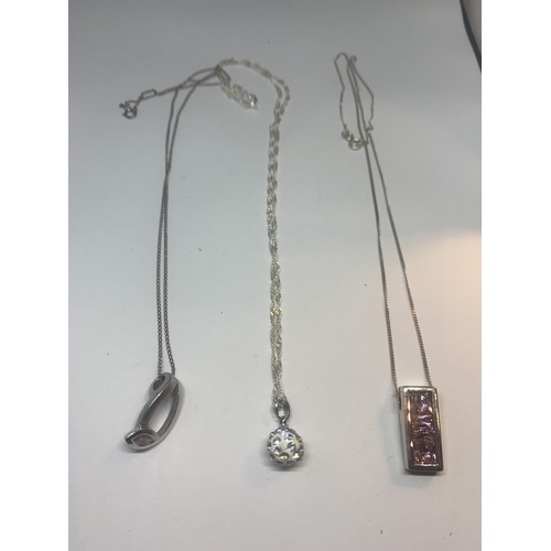 525 - THREE SILVER NECKLACES TWO WITH PINK STONE PENDANTS AND ONE WITH A CLEAR STONE BALL